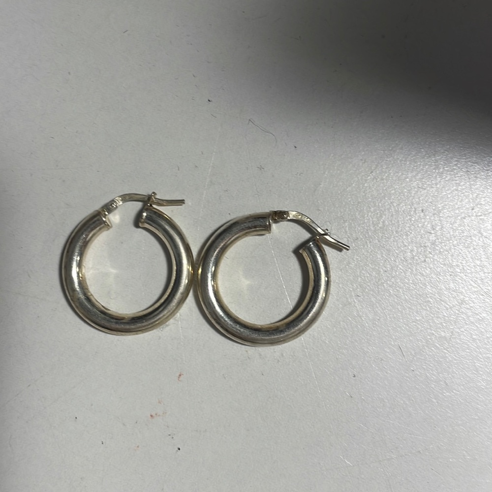 one pair of chunky silver hoops, never worn